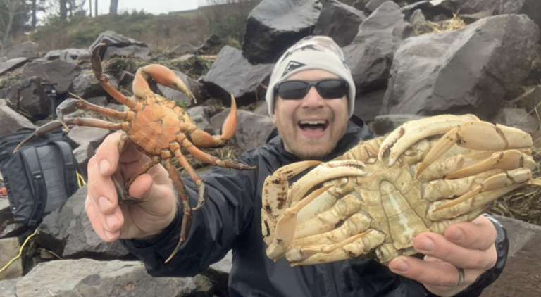 Will holding two crabs caught from shore.