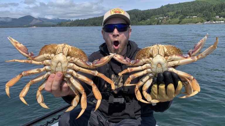 Will holding two crabs, one in each hand.